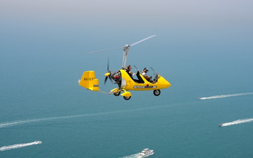 Gyrocopter flying over the sea at Skydive Dubai Palm Drop Zone.