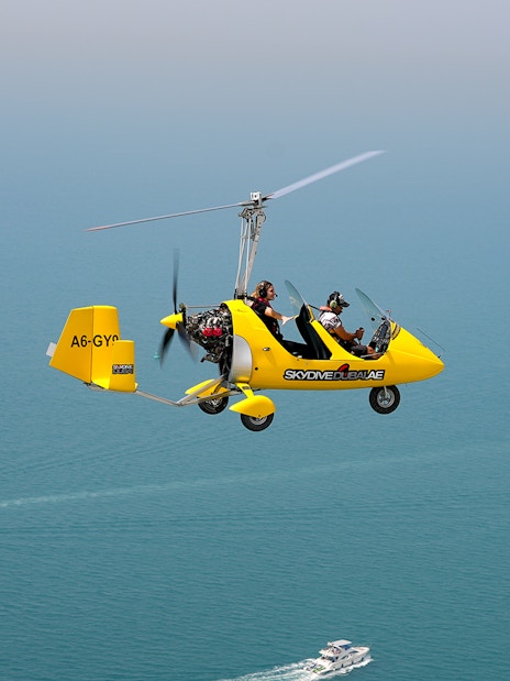 Gyrocopter flying over the sea at Skydive Dubai Palm Drop Zone.