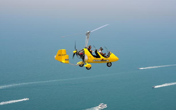 Gyrocopter flying over the sea at Skydive Dubai Palm Drop Zone.
