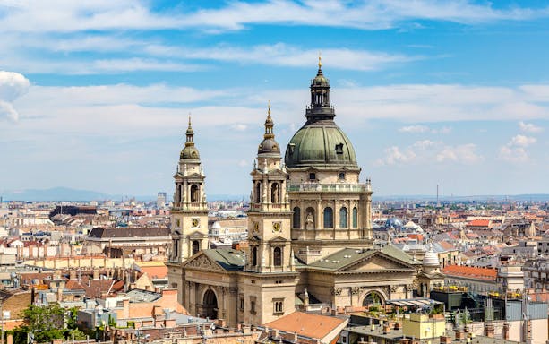 St. Stephen's Basilica with Budapest skyline during walking tour.