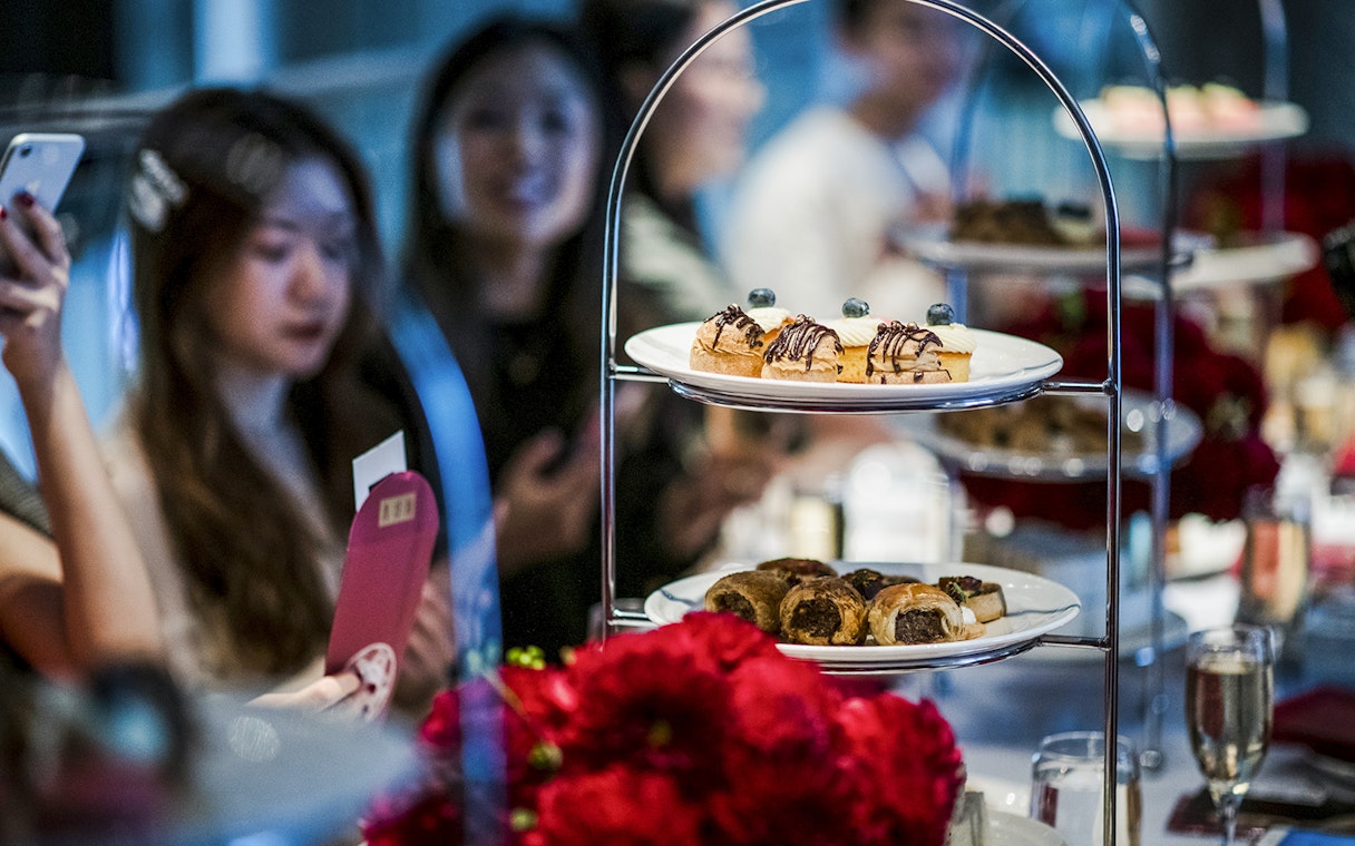 Guests enjoying high tea with pastries at National Gallery of Victoria.