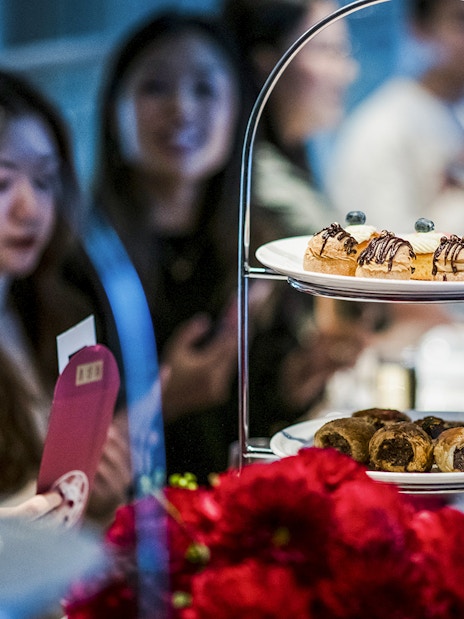 Guests enjoying high tea with pastries at National Gallery of Victoria.