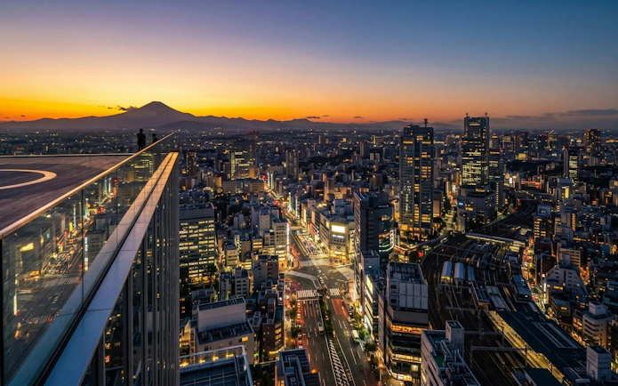 Tokyo skyline at sunset from Shibuya Sky, overlooking Shibuya Scramble Crossing.