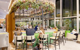 VIP lounge bar area at Istanbul Airport with people seated and enjoying drinks.
