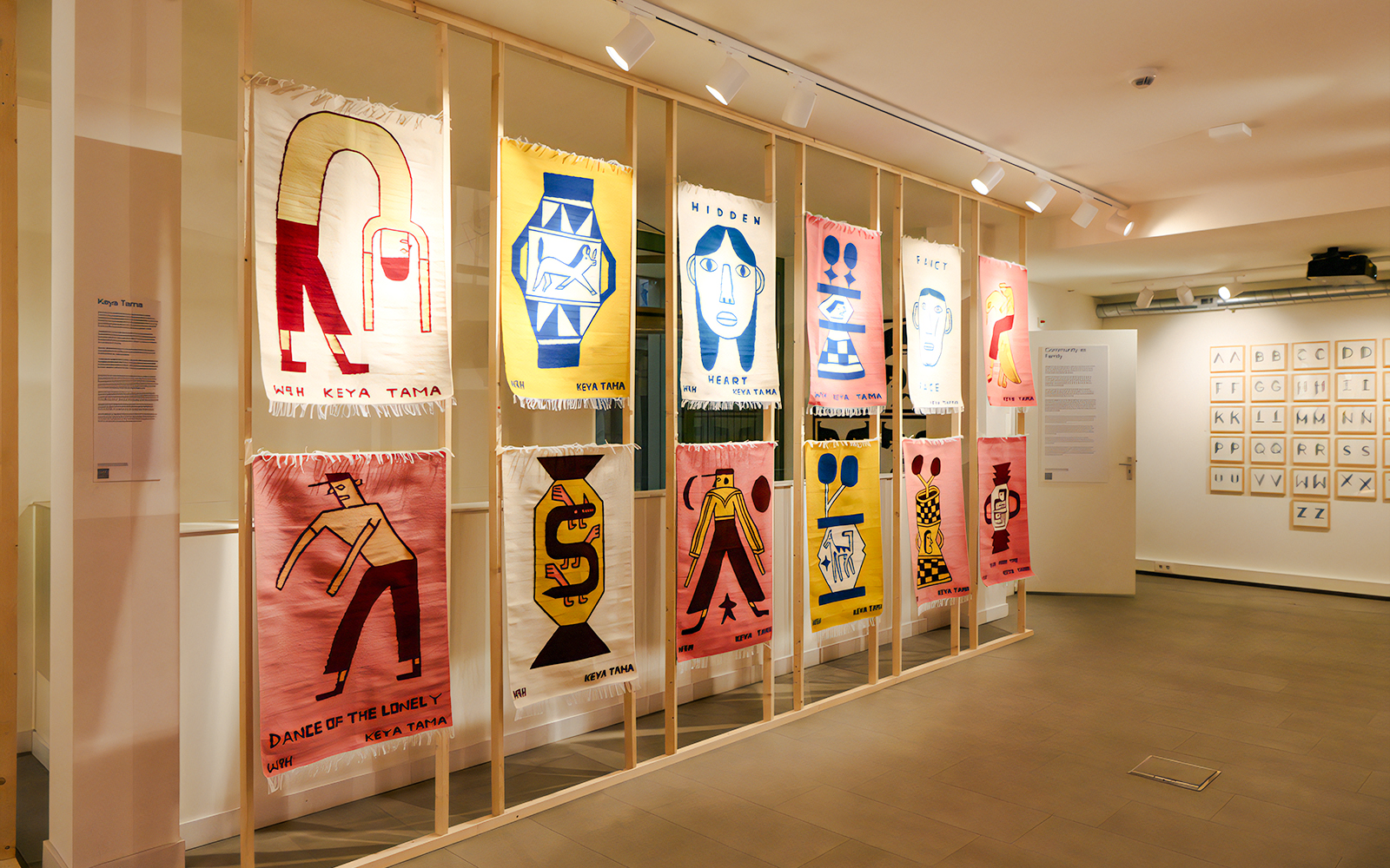 Textile art display at Straat Museum featuring colorful abstract designs.