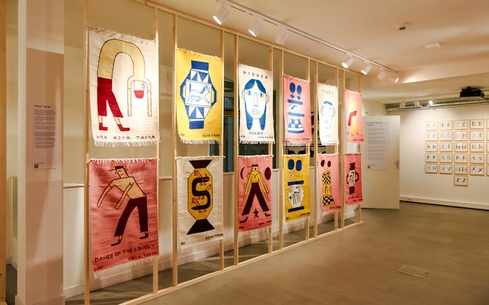 Textile art display at Straat Museum featuring colorful abstract designs.