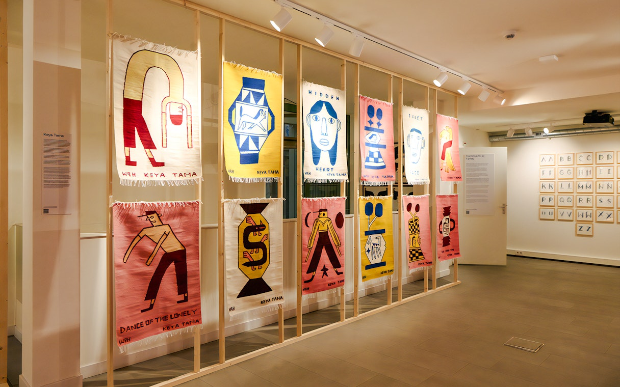 Textile art display at Straat Museum featuring colorful abstract designs.