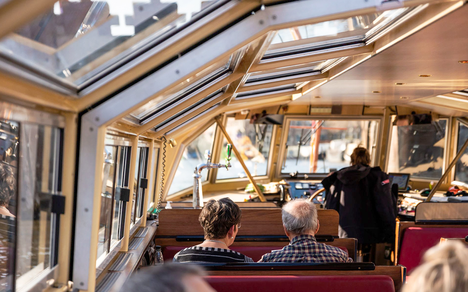 Interior of a canal boat with passengers on an Amsterdam Food & History Tour.