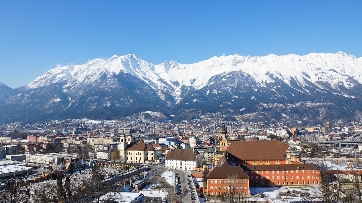 Innsbruck cityscape with snow-covered Nordkette mountain range in the background, Austria.