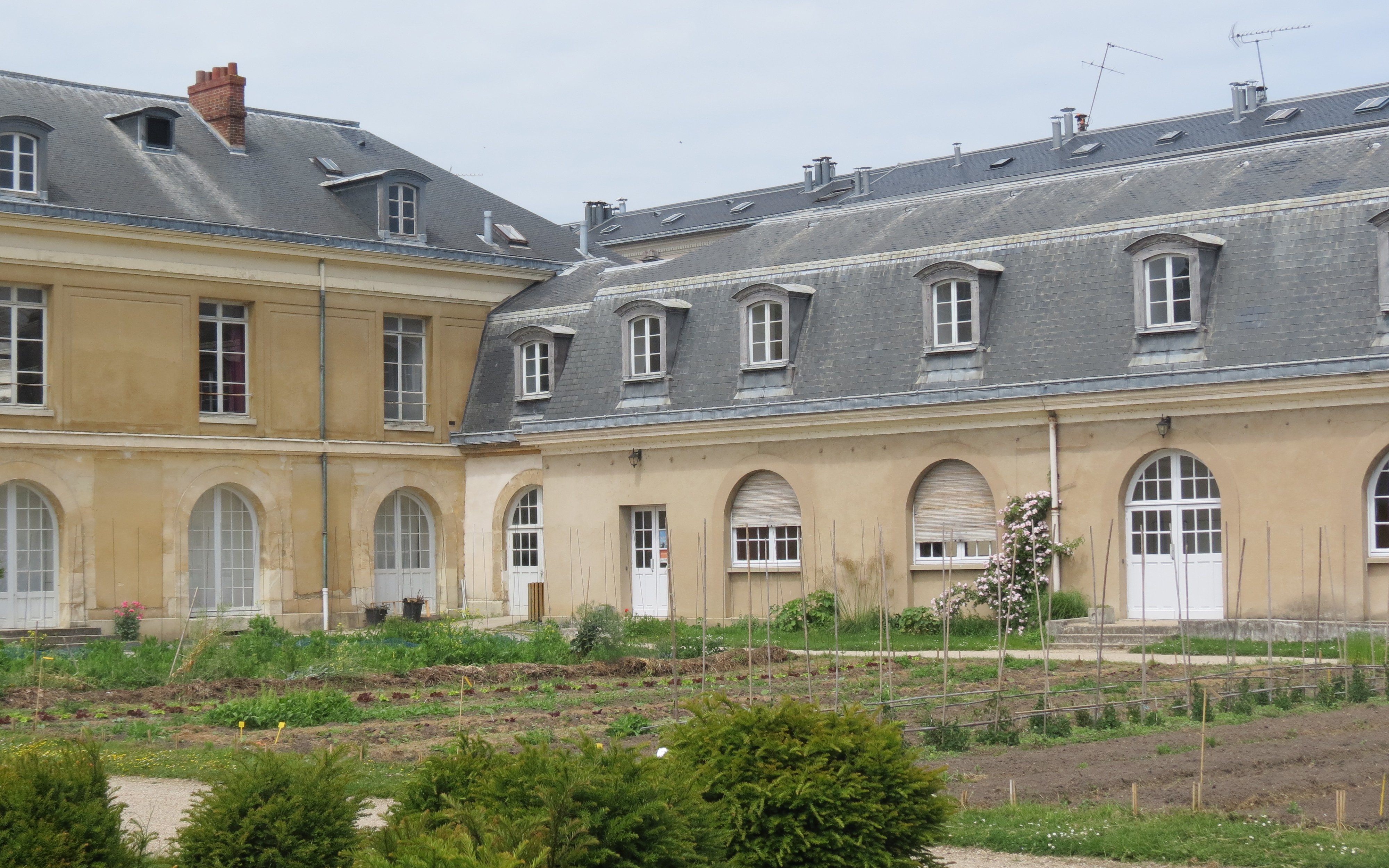 Potager du Roi garden with historic building in Versailles, France.