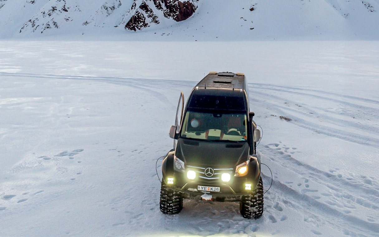 All-terrain vehicle on snowy terrain for South Coast & Katla Ice Cave tour from Reykjavik.