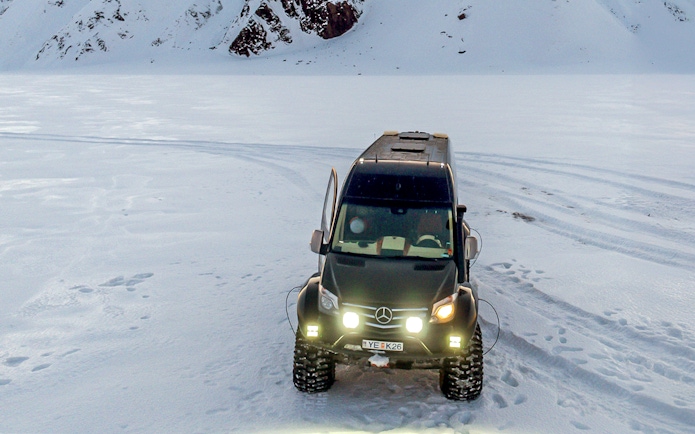 All-terrain vehicle on snowy terrain for South Coast & Katla Ice Cave tour from Reykjavik.