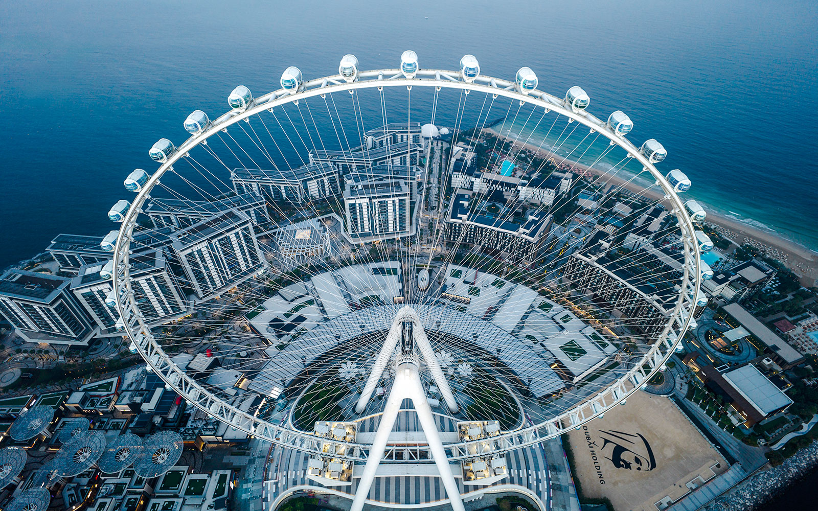 Aerial view of Ain Dubai Ferris wheel overlooking the cityscape and coastline.