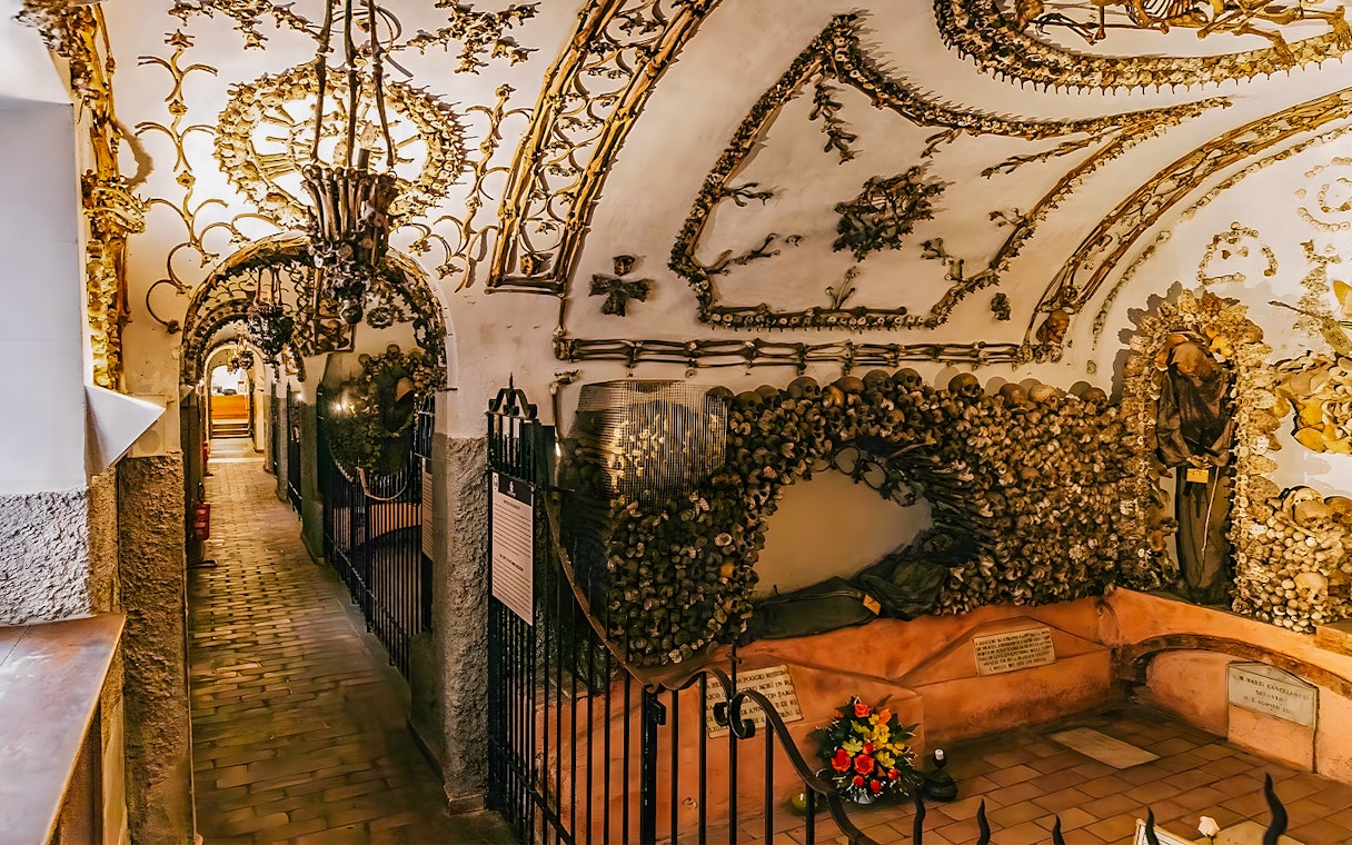 Capuchin Crypts corridor adorned with bones and religious artifacts, part of the Roman Catacombs tour.