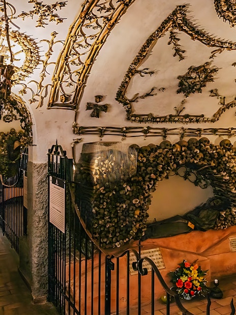 Capuchin Crypts corridor adorned with bones and religious artifacts, part of the Roman Catacombs tour.
