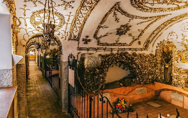 Capuchin Crypts corridor adorned with bones and religious artifacts, part of the Roman Catacombs tour.