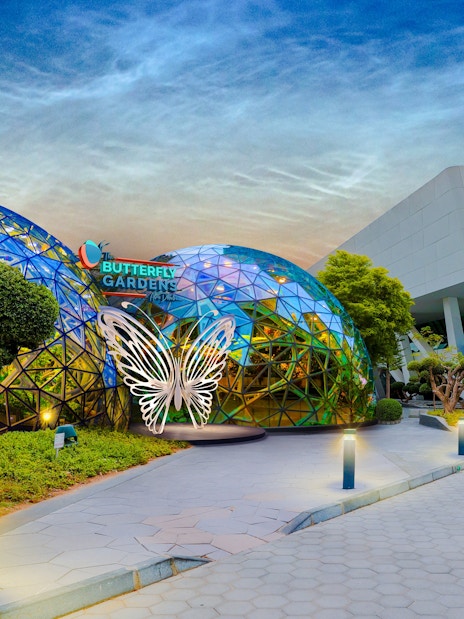 Butterfly Garden entrance with glass domes and butterfly sculpture, adjacent to National Aquarium.