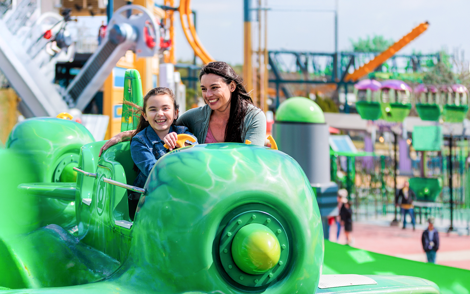 Visitors enjoying GREEN LANTERN™ Emerald Flight ride at Six Flags Fiesta Texas.
