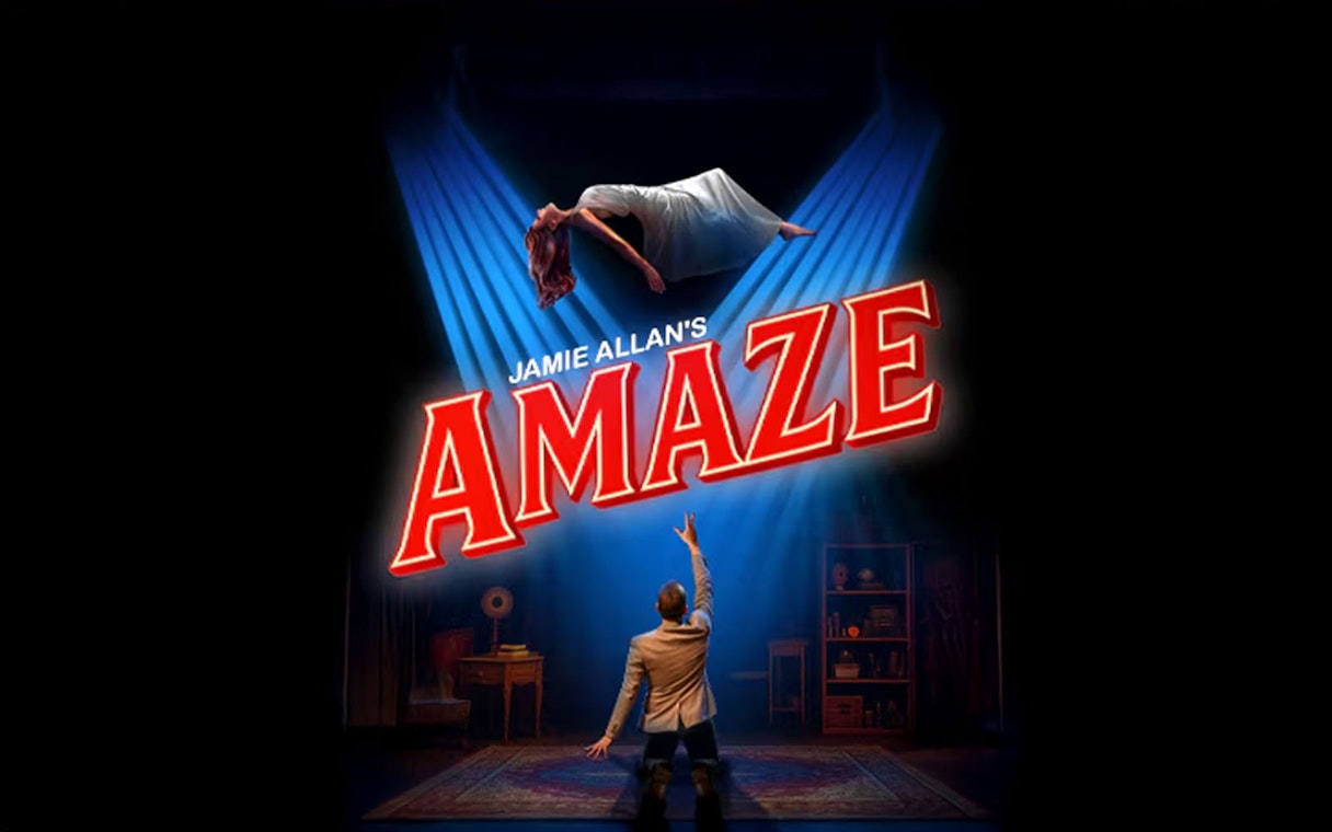 Magician performing levitation trick in Jamie Allan's Amaze show