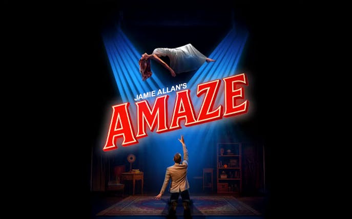Magician performing levitation trick in Jamie Allan's Amaze show