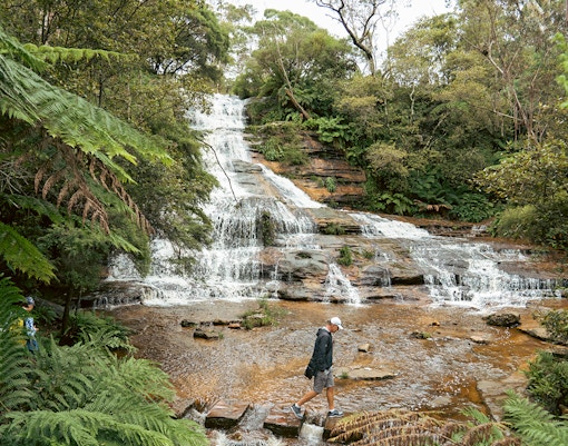 Man walking near Katoomba Cascades waterfalls in Blue Mountains, Australia.