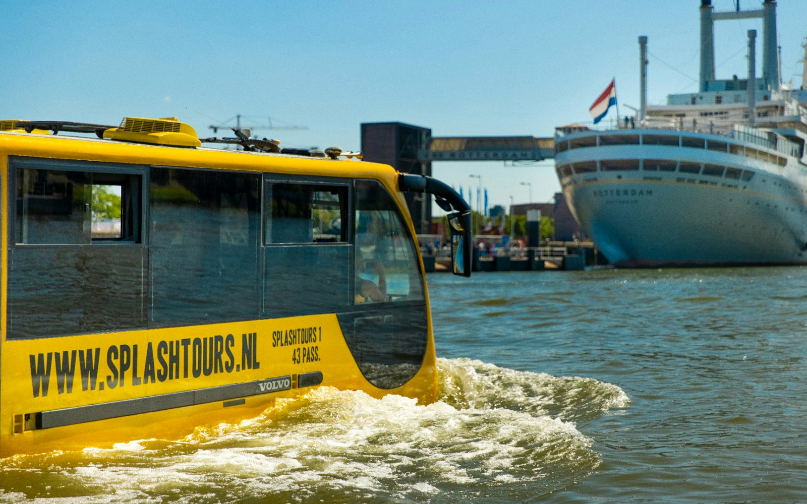 Amphibious vehicle cruising through Amsterdam canals on 1-hour sightseeing splash tour.