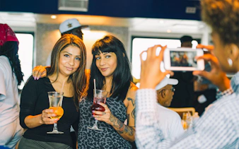 Guests enjoying drinks on the Signature Bottomless Mimosa Brunch Cruise in Washington DC.