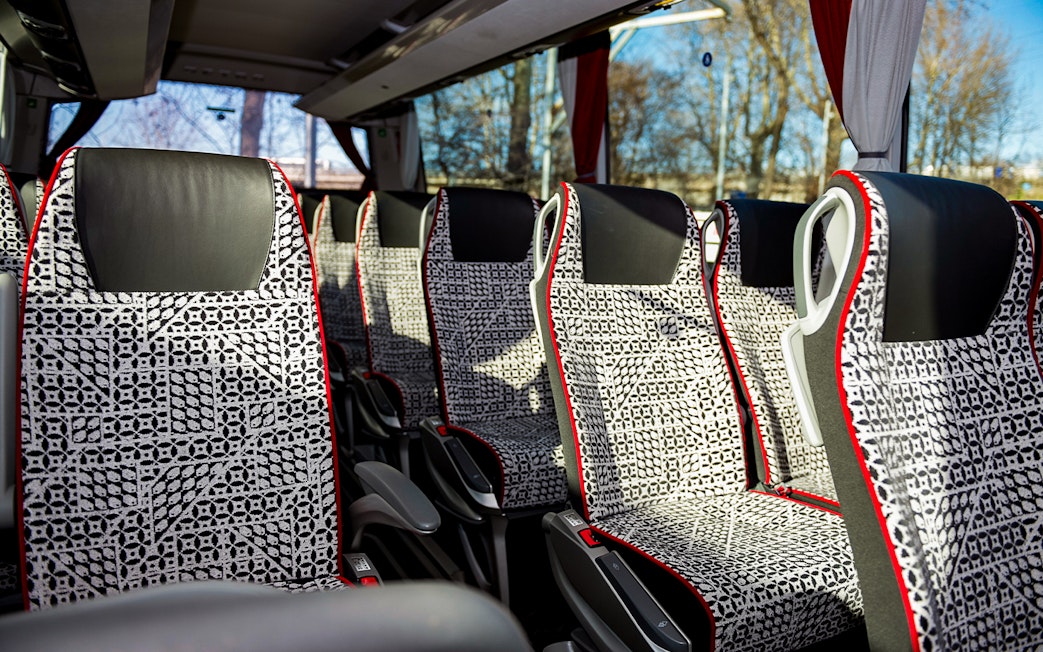SIT Bus Shuttle seats with patterned upholstery and armrests.