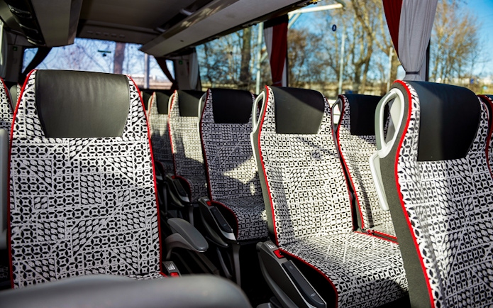 SIT Bus Shuttle seats with patterned upholstery and armrests.