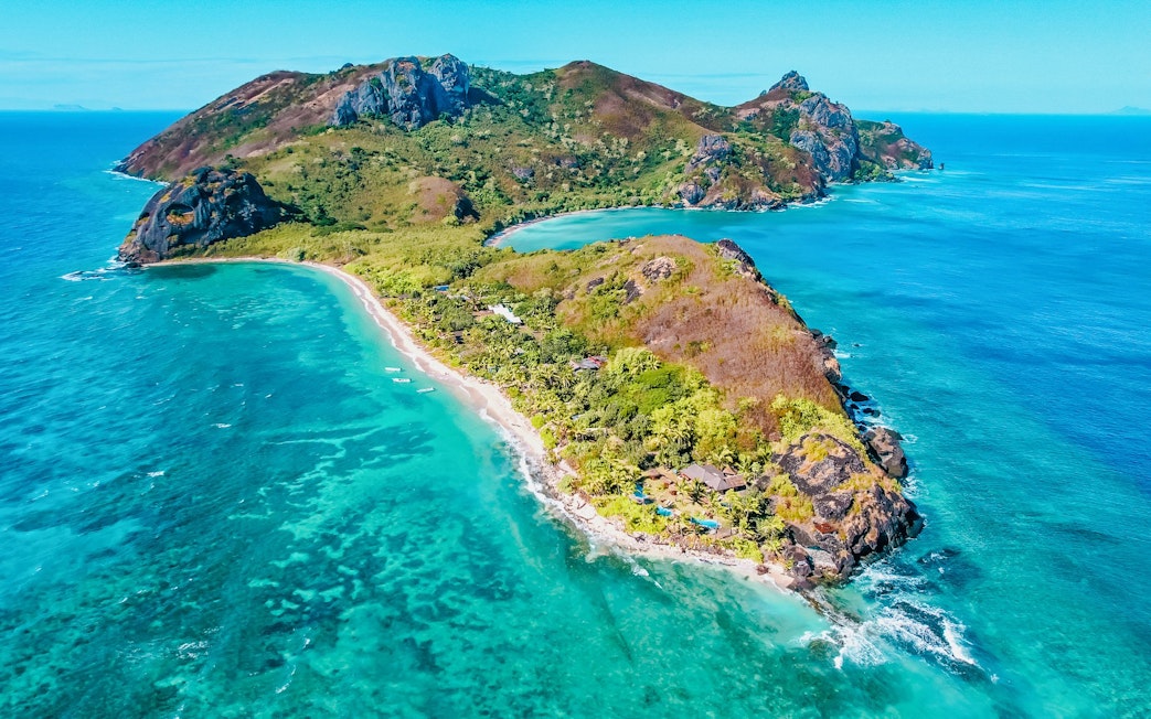 Aerial view of Kuata Island resort with lush greenery and turquoise waters, Fiji.
