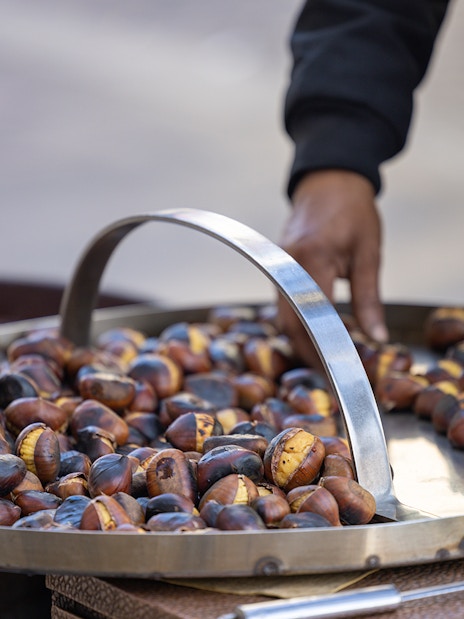 Roasted chestnuts on a tray during a guided food and wine tour in Prati.
