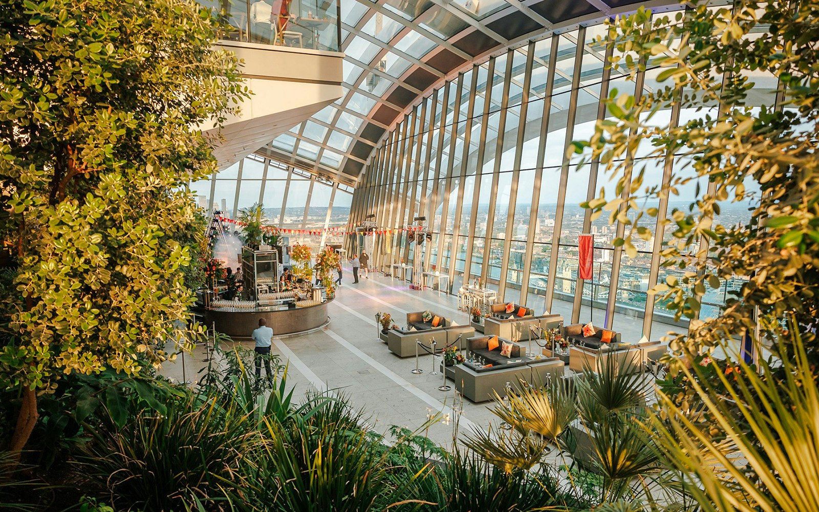 Sky Garden London interior with evening city views and lush greenery.