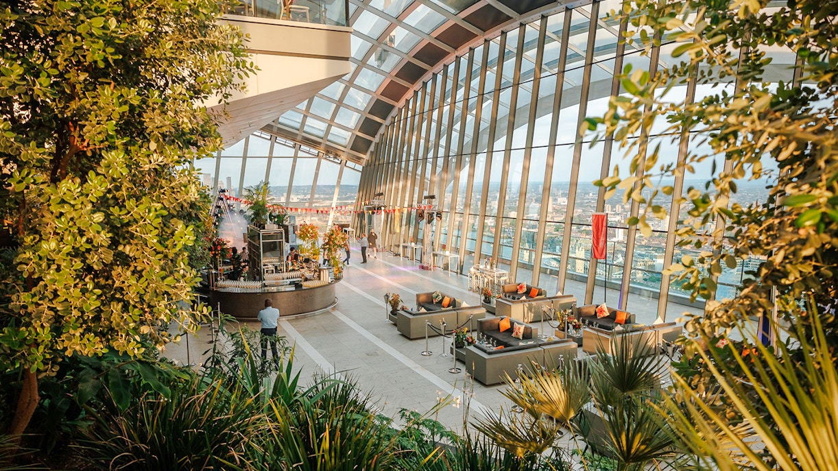 Sky Garden London interior with evening city views and lush greenery.