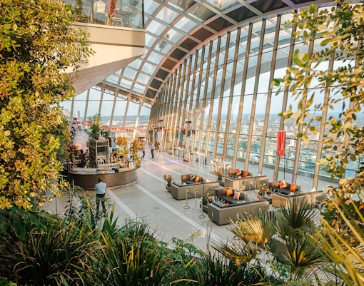 Sky Garden London interior with evening city views and lush greenery.