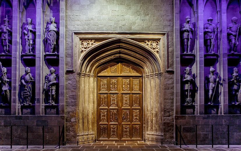Entrance to the Great Hall at The Making of Harry Potter tour, featuring ornate wooden doors.