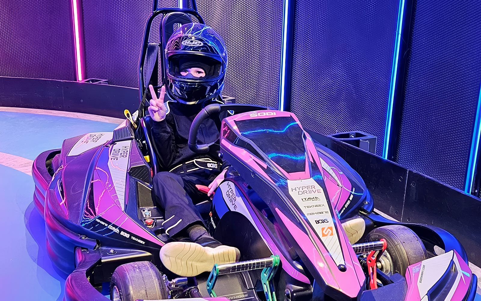 Go-kart driver in HyperDrive arena, part of Combo: HyperDrive and UltraGolf experience.