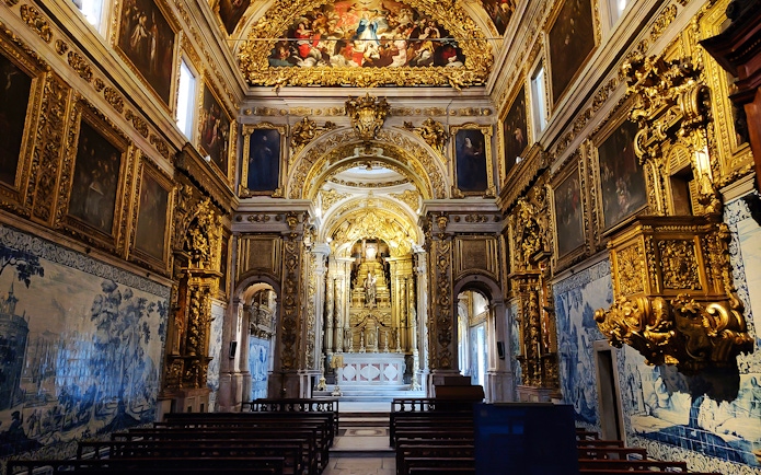 Main altar of National Tile Museum in Lisbon, featuring ornate gold detailing and azulejo tiles.