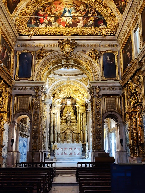 Main altar of National Tile Museum in Lisbon, featuring ornate gold detailing and azulejo tiles.