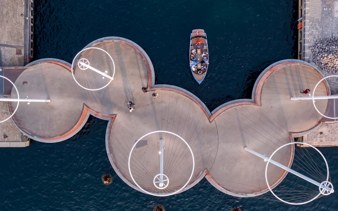 Aerial view of a boat passing under the Cirkelbroen bridge in Copenhagen during a canal tour.