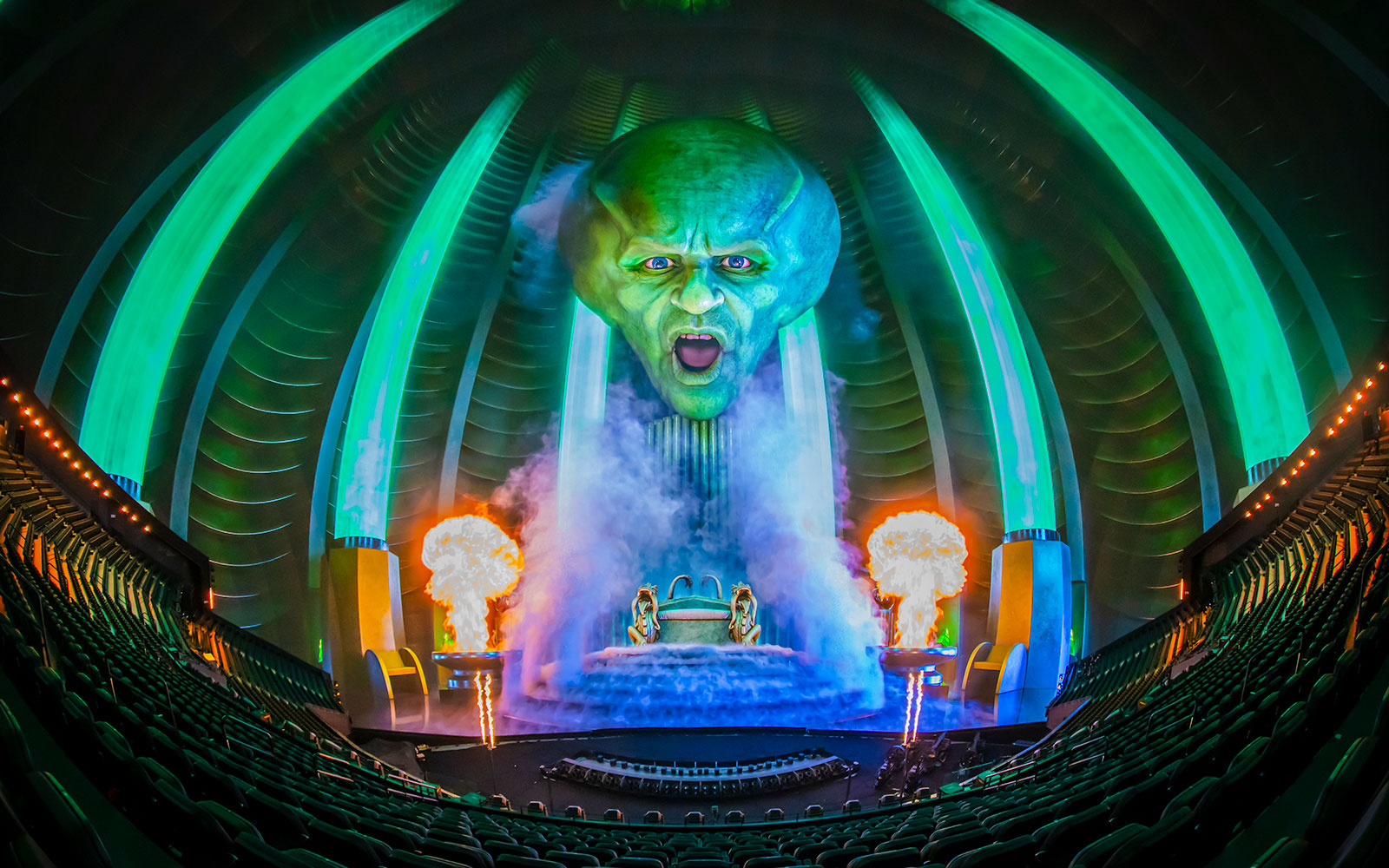 Wizard of Oz show at Sphere with giant green head and fiery effects.