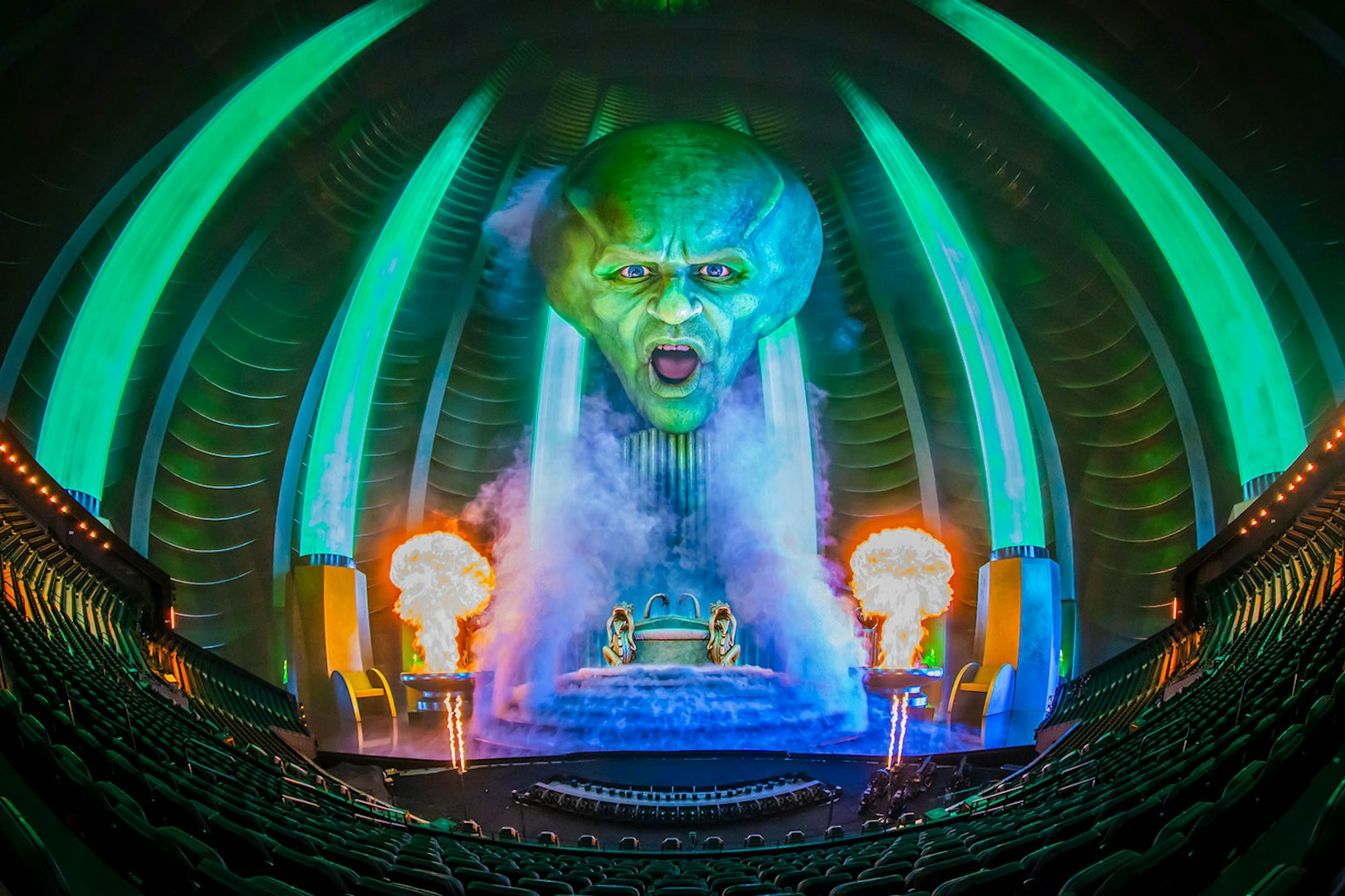 Wizard of Oz show at Sphere with giant green head and fiery effects.