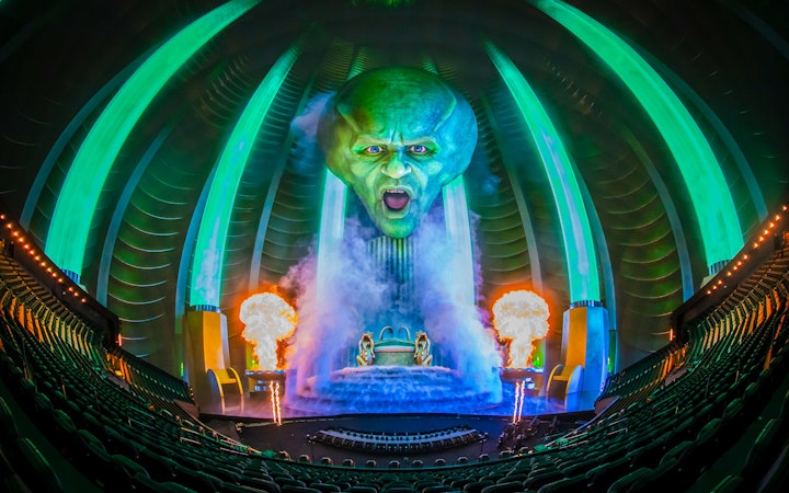 Wizard of Oz show at Sphere with giant green head and fiery effects.