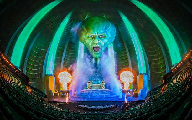 Wizard of Oz show at Sphere with giant green head and fiery effects.