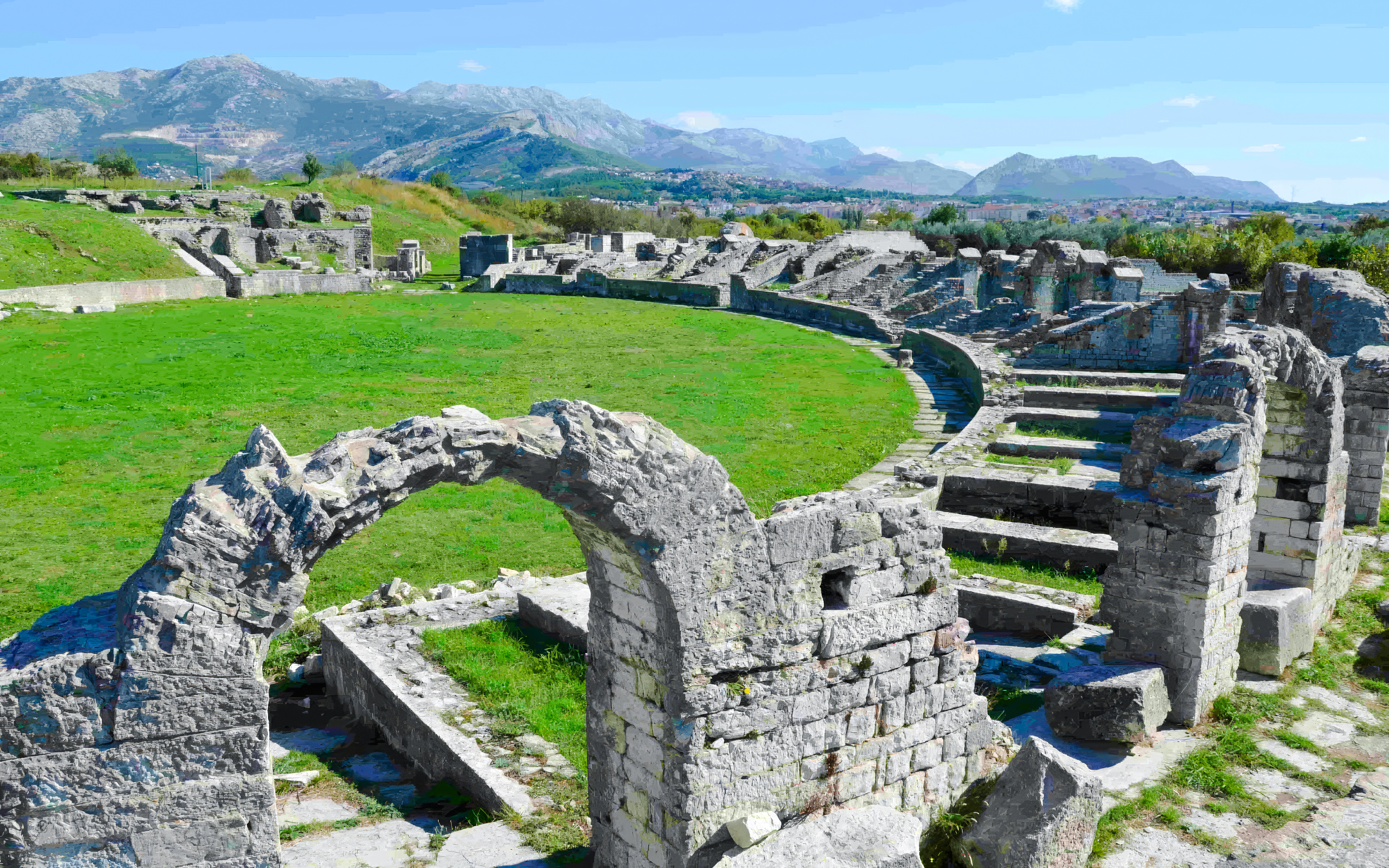 Roman Amphitheatre ruins in Salona, Solin, Croatia, with stone arches and seating.