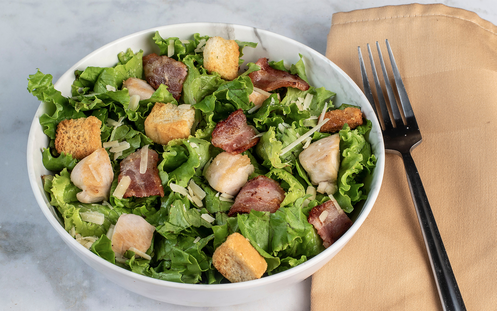Caesar salad with croutons and parmesan at a New York City lunch cruise.