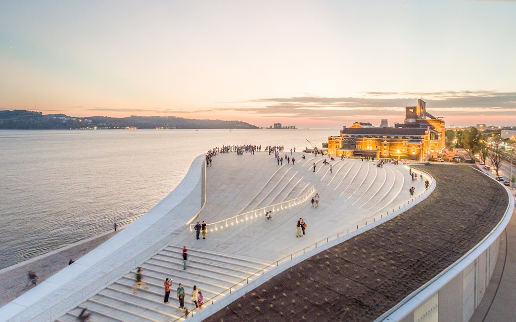 MAAT museum rooftop with people at sunset, Lisbon.