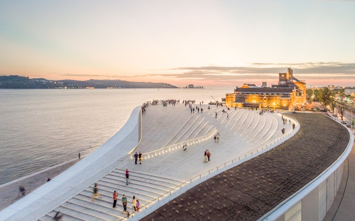 MAAT museum rooftop with people at sunset, Lisbon.
