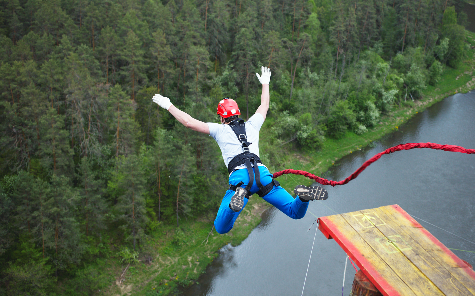 Bungee jumping experience near Blue Planet Aquarium, showcasing thrill-seekers mid-jump.
