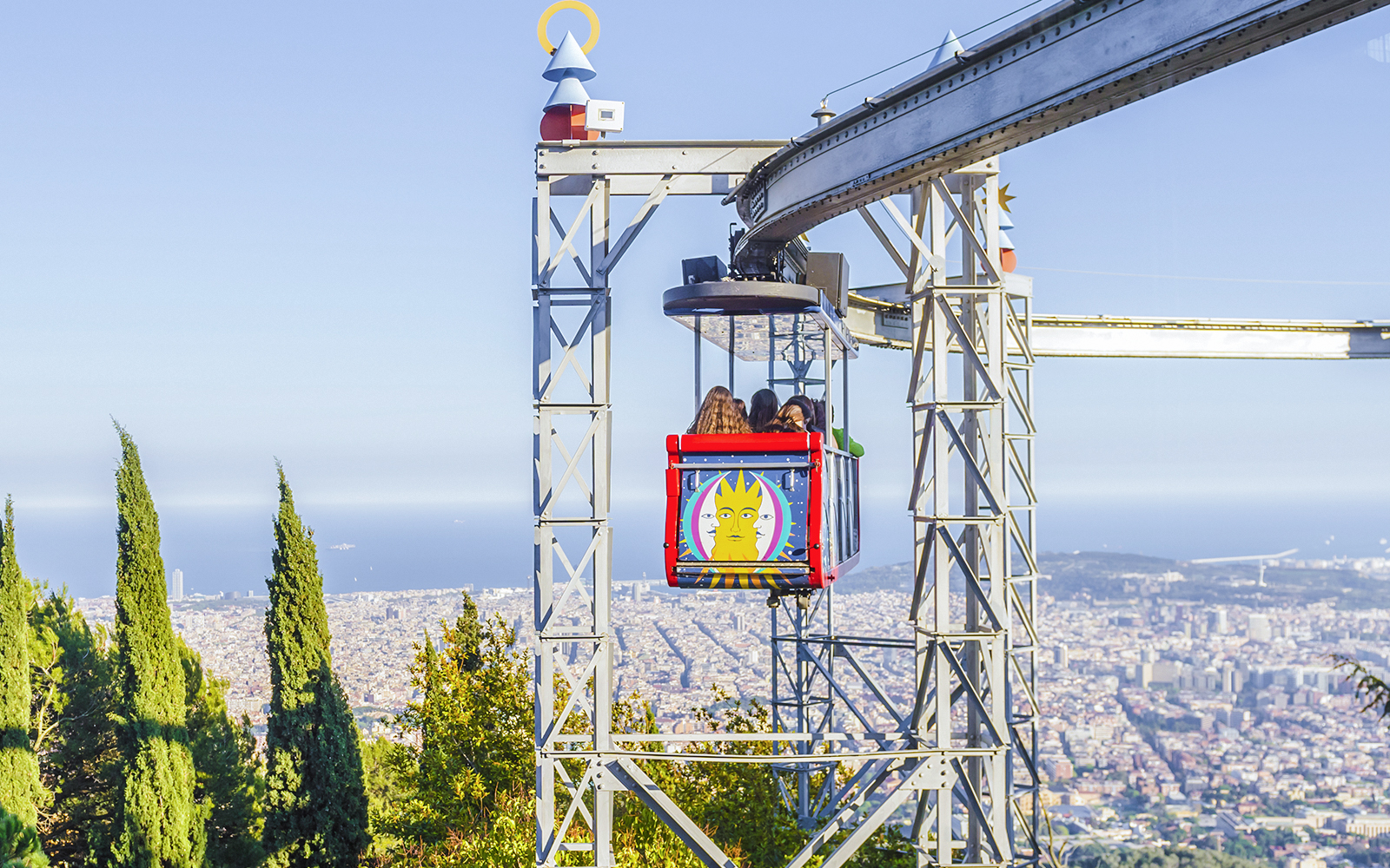Tibidabo amusement park ride with city view in Barcelona.