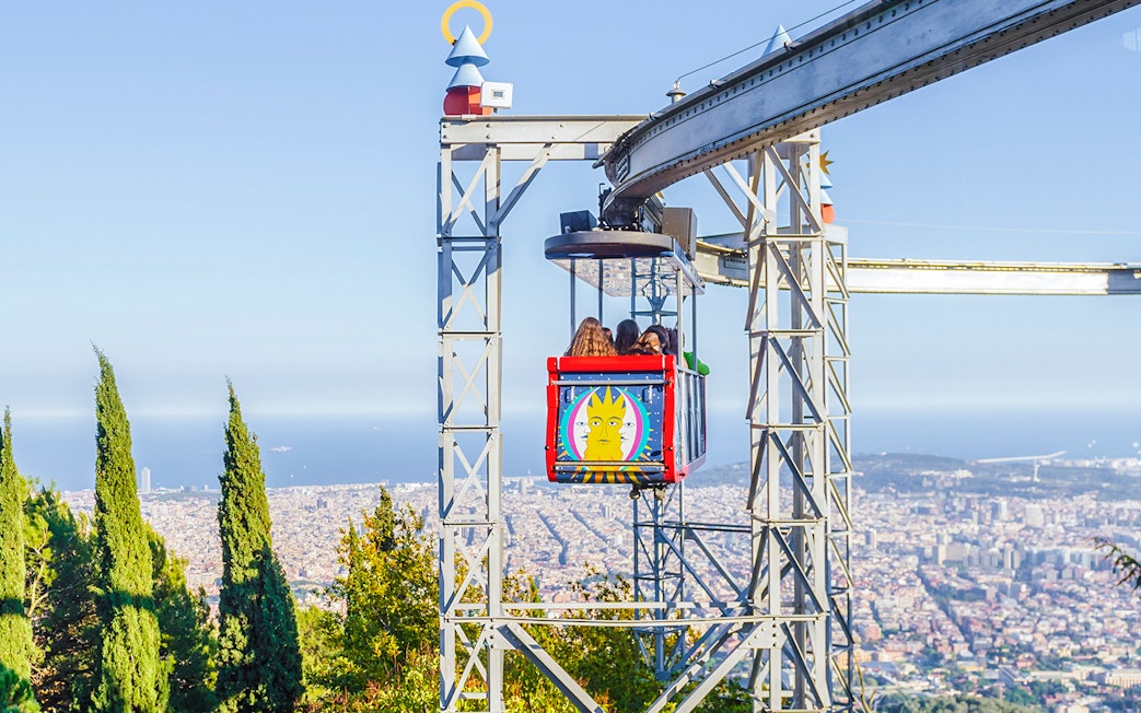 Tibidabo amusement park ride with city view in Barcelona.